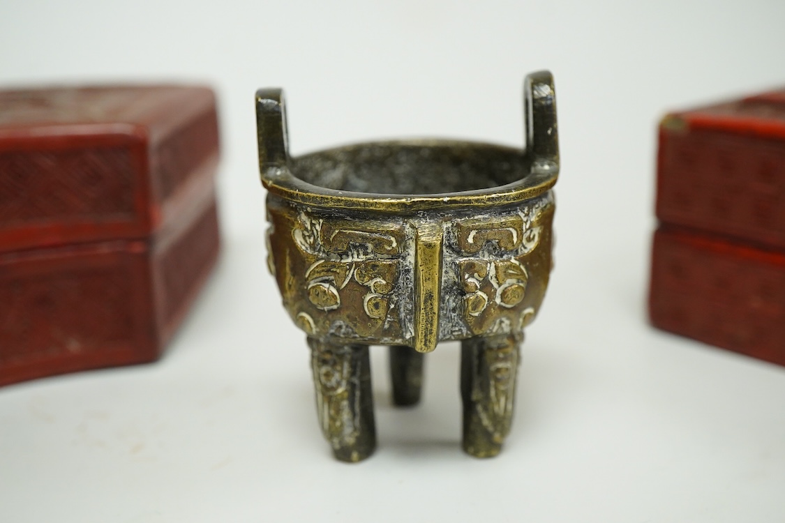 Two Chinese cinnabar lacquer boxes and a Chinese archaistic miniature bronze tripod censer, rectangular lacquer box 11.5cm high x 7.5cm deep